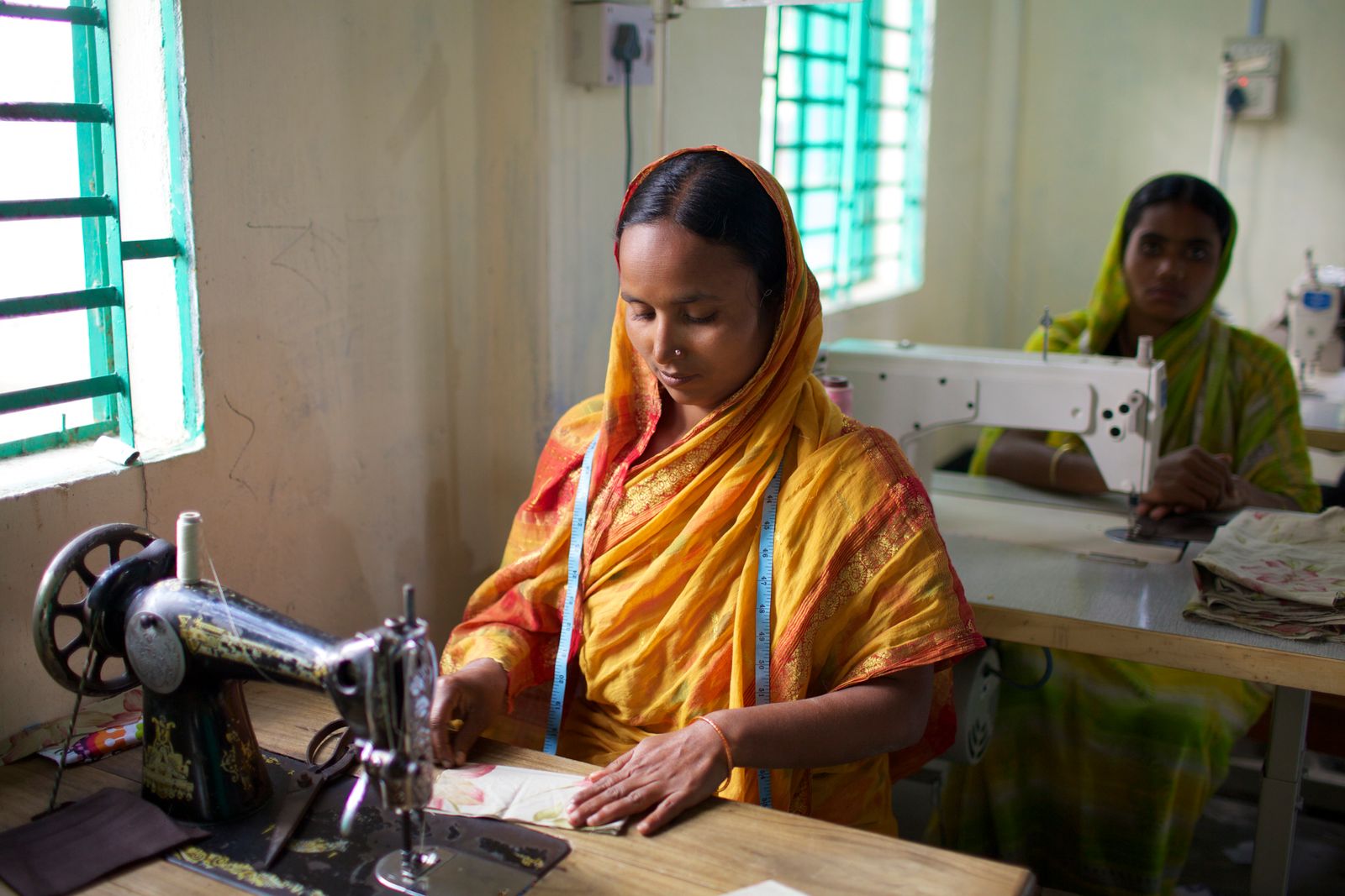 Bangladeshi women sewing garments at sewing machines